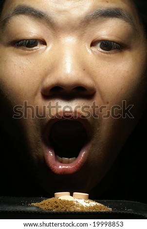 Man with open mouth and pills