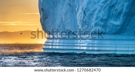Iceberg at sunset. Nature and landscapes of Greenland. Disko bay. West Greenland.