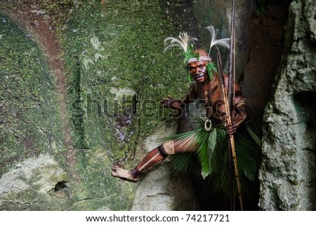 NEW GUINEA, INDONESIA - 2 FEBRUARY: The warrior of a Papuan tribe of Yafi in traditional clothes, ornaments and coloring. New Guinea Island, Indonesia. February 2, 2009.