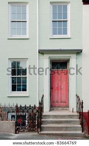 Red  door and window. A red door with ladder steps and windows.Guernsey