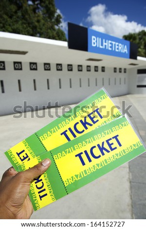 Brazilian soccer fan holds two tickets outside football stadium ticket window