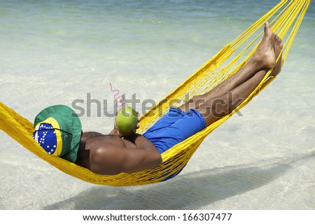 stock-photo-man-relaxes-in-hammock-on-brazilian-beach-drinking-coconut-water-166307477.jpg