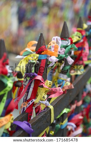 Colorful religious Brazilian wish ribbons Fita do Bonfim tied on church gate in Salvador Brazil