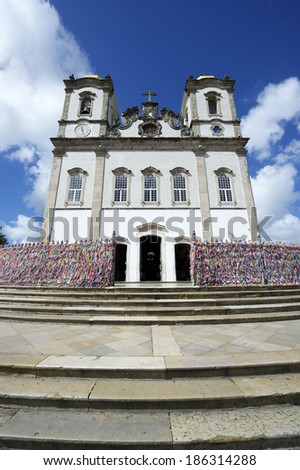 Steps leading up to colorful wall of wish ribbons at the entrance to the Igreja Nosso Senhor do Bonfim da Bahia church in Salvador Bahia Brazil