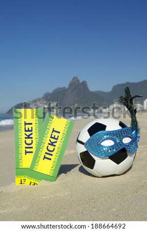 Brazil tickets stand next to soccer theme Rio Carnival football wearing sparkly mask on Ipanema Beach