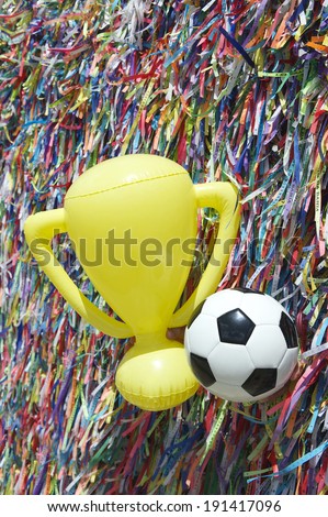 Good luck football soccer ball and championship trophy at wall of Brazilian wish ribbons at the Bonfim church in Salvador Bahia Brazil