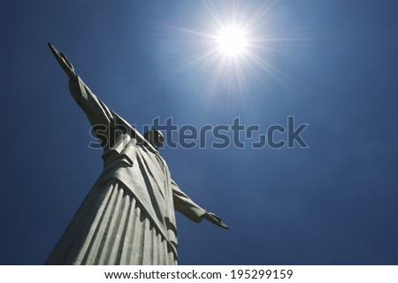 RIO DE JANEIRO, BRAZIL - OCTOBER 20, 2013: Statue of Christ the Redeemer at Corcovado Mountain standing under bright sun against blue sky.