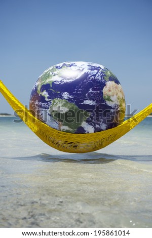 World Cup Brazil globe relaxing in bright yellow hammock above tropical beach sea