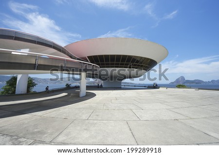 RIO DE JANEIRO, BRAZIL - FEBRUARY 4, 2014: The modernist Niteroi Contemporary Art Museum (MAC) by Oscar Niemeyer features a long curving ramp entrance and wide plaza.