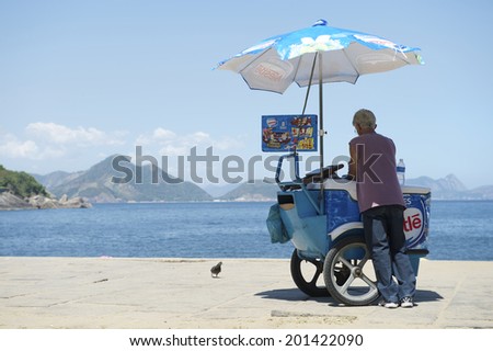 RIO DE JANEIRO, BRAZIL - FEBRUARY 11, 2014: Brazilian beach vendor selling ice cream stands at the entrance to Red Beach in Urca.