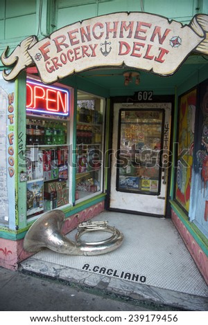 NEW ORLEANS, USA - JULY 24, 2014: A tuba rests in the colorful entrance to a store named Frenchmen Grocery in the French Quarter.