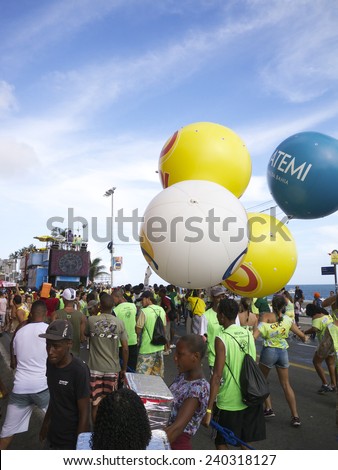 SALVADOR, BRAZIL - FEBRUARY 9, 2013: People and advertising balloons follow the Barra Ondina route of Salvador Carnival.