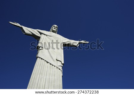 RIO DE JANEIRO, BRAZIL - MARCH 05, 2015: Statue of Christ the Redeemer stands in clear blue sky in bright morning sun.