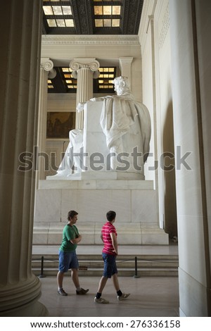 WASHINGTON DC, USA - JULY 30, 2014: Tourists explore the halls of the Lincoln Memorial, the Parthenon-inspired building housing the seated statue of Abraham Lincoln.