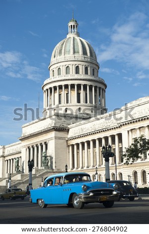HAVANA, CUBA - JUNE, 2011: Classic American Cuban taxi car passes in front of the Capitolio building in Central Havana.