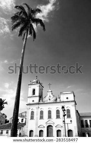 Colonial church architecture of Anchieta Plaza with tall royal palm in Pelourinho Salvador Bahia Brazil
