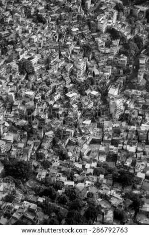 Stark black and white view of crowded Brazilian Rocinha favela shanty town on a hillside in Rio de Janeiro Brazil