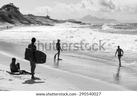 RIO DE JANEIRO, BRAZIL - MARCH 24 2015: Body boarders get ready to hit the waves of Praia do Diabo (Devil\'s Beach) at the famous surf spot of Arpoador.