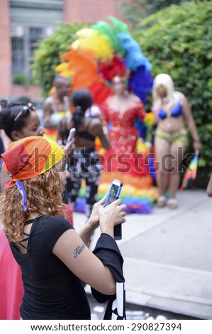 NEW YORK CITY, USA - JUNE 30, 2013: Drag queens in dramatic costumes gather on a Greenwich Village sidewalk to pose for pictures during the annual gay pride event.