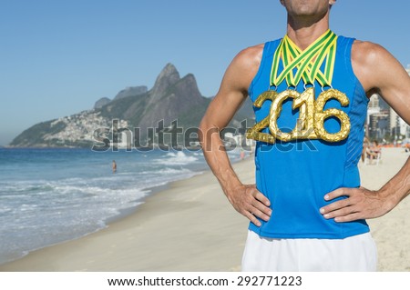 First place athlete wearing 2016 gold medals standing outdoors on Ipanema Beach in Rio de Janeiro Brazil