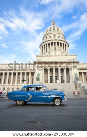 HAVANA, CUBA - JUNE, 2011: Classic American Cuban taxi car passes in front of the Capitolio building in Central Havana.