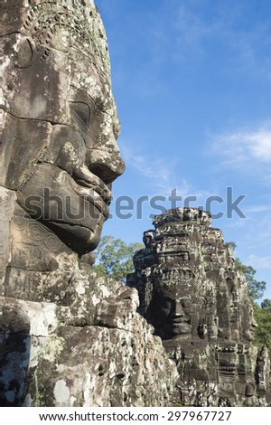 Bayon Temple stone face sculpture under blue sky at Angkor Wat