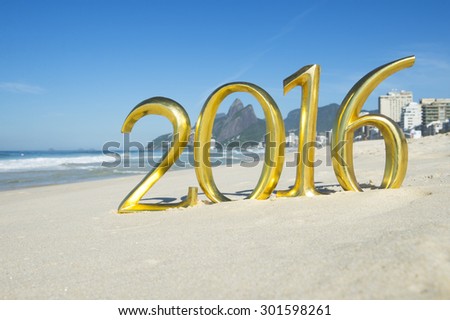 Golden New Year 2016 message standing on the smooth sand of Ipanema Beach in Rio de Janeiro, Brazil