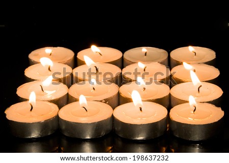 Square of candles isolated on black background
