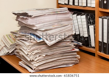 Newspapers isolated on desktop front of folders