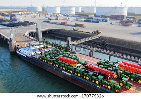 ROTTERDAM, SOUTH HOLLAND, NETHERLANDS - MARCH 28: Tractors loaded onto cargo barge in the Port of Rotterdam on March 28, 2013 in Rotterdam, South Holland, Netherlands.