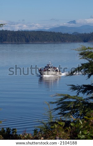 Whale watching boat passing Telegraph Cove on Vancouver Island, Canada