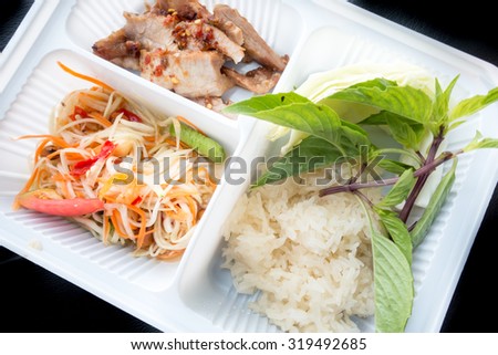 Thai papaya salad, BBQ pork and sticky rice in take away box, Bangkok