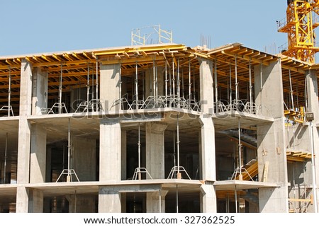 Construction of a new carcass house with using the concrete monolithic technology on a background of blue cloudless sky