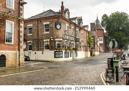 York, Uk - September 29, 2014: Traditional Pub and Brick Buildings in the old City Centre. York is a historic walled city at the confluence of the Rivers Ouse and Foss in North Yorkshire.
