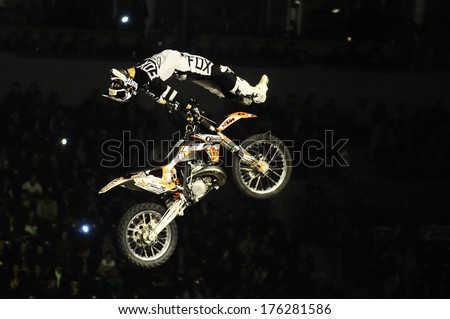 SERBIA, BELGRADE - APRIL 6, 2013: Motorbike rider performing the trick at Masters of dirt show at Kombank arena, most thrilling and spectacular freestyle motocross show