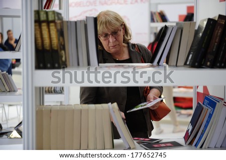 SERBIA, BELGRADE - OCTOBER 21, 2013: People choosing a book at the International Belgrade Book Fair, one of the oldest and most important literary events in the region
