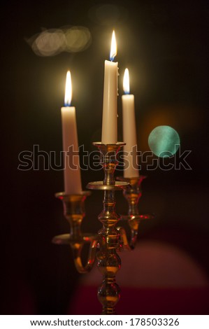 candle holder with white candle lit in restaurant