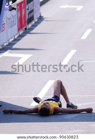 BELGRADE, SERBIA - APRIL 17: An unidentified runner lays down at the finish of the 24th Belgrade Marathon on April 17, 2011 in Belgrade, Serbia.