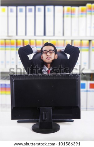 Asian businessman falling to sleep at the office