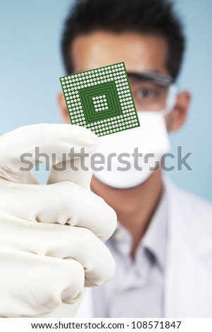 Portrait of scientist showing a microchip computer. shot in studio
