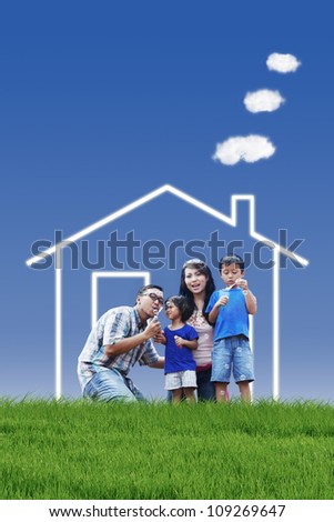 Portrait of asian family with dream house playing bubble outdoor