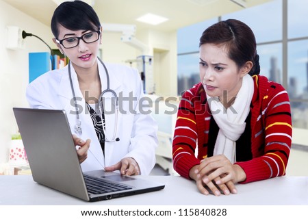 Female doctor is explaining her diagnose to her patient via laptop