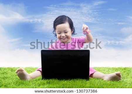 Asian girl is learning computer in the park