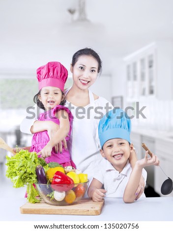 Happy family with fresh vegetable at home