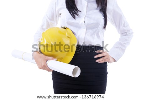 Close-up of businesswoman holding yellow safety helmet and plan