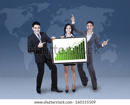Group of happy business colleagues holding growth graph on world map background
