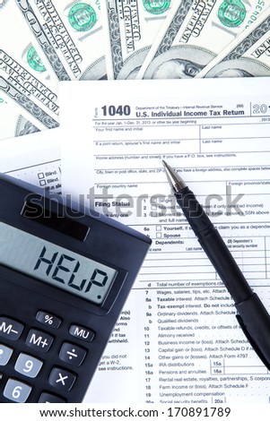 Tax time concept with an Official USA tax form, money, calculator, and a pen