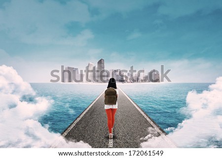 Young female student approaching a big city through the road