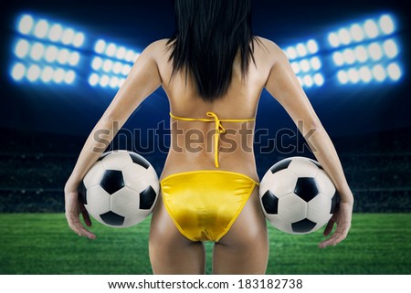 Woman\'s Sexy Backside Holding a Soccer Ball. Shoot at soccer stadium