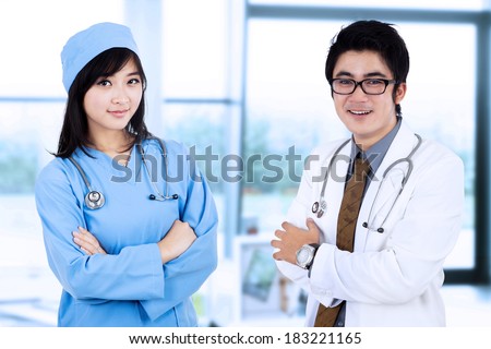 Portrait of male doctor and a female surgeon in pose. shooting at hospital